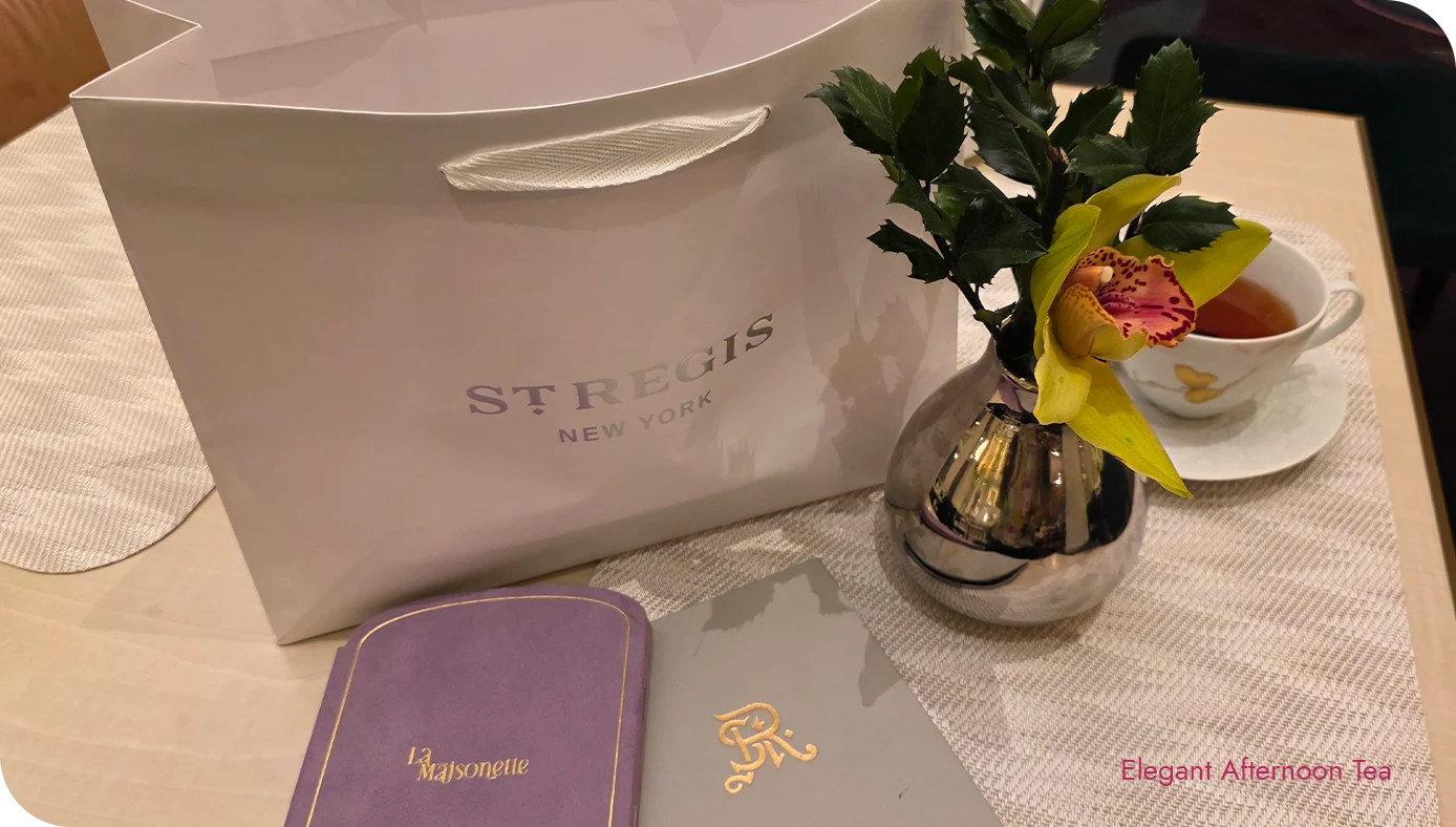 Takeaway bag beside an orchid arrangement and a teacup at the afternoon tea table