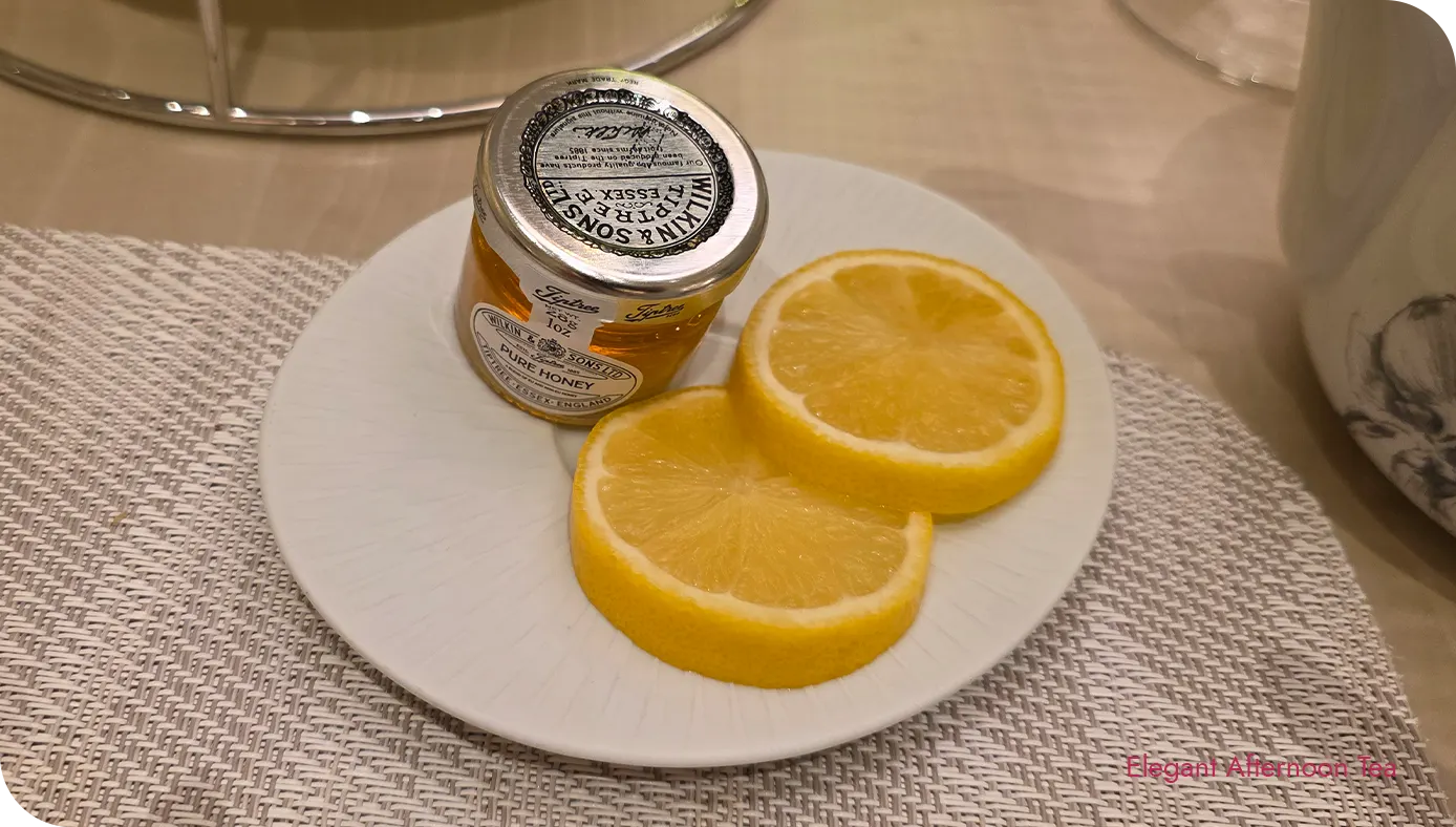 Mini honey jar and lemon slices served with tea at The St. Regis New York afternoon tea