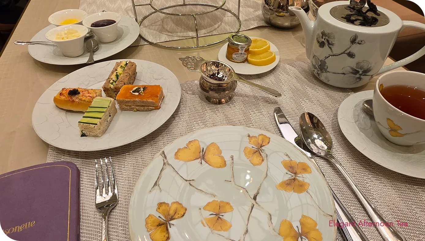 Savory course plate at St. Regis New York Ladurée afternoon tea with teapot and teacup on the table